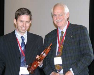 Dr. Robert Baird (R.) presents the Dr. Charles H. Miller Award for 2007 to Dr. Pierre-Jean Arnoux (L.)